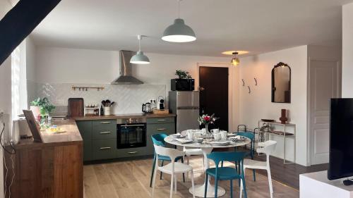 a kitchen with a table and chairs in a room at Le Printemps 