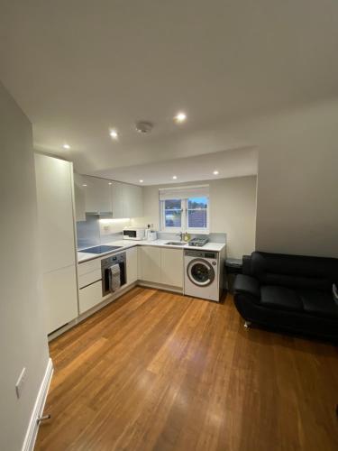 a kitchen with a washer and dryer in a room at Cavendish Apartments in High Wycombe