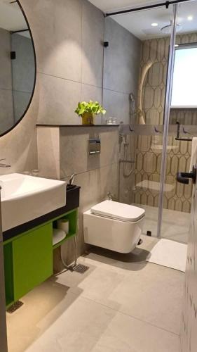 a bathroom with a sink and a toilet and a shower at ZIBE Luxe Hyderabad by GRT Hotels in Hyderabad