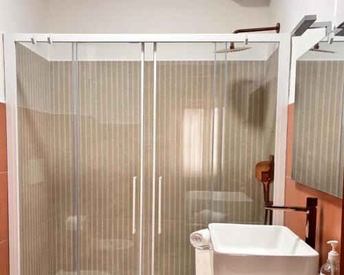 a bathroom with a shower and a toilet and a sink at Be Your Home - Cruise Stop Guest House in Civitavecchia