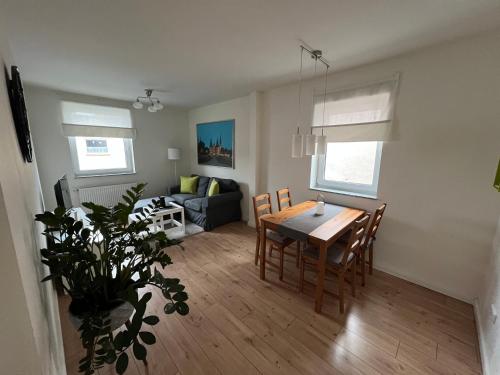 a dining room and living room with a table and chairs at Mara in Lübeck