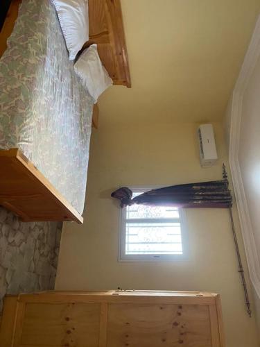 a bedroom with a bunk bed and a window at Ebreezy1 villa 2 in Brufut