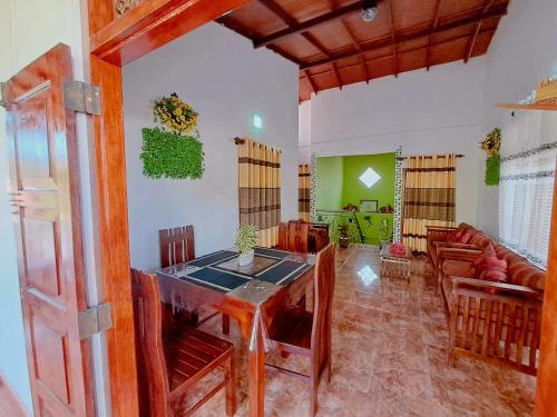 a living room with a table and a couch at Linu Villa in Hikkaduwa
