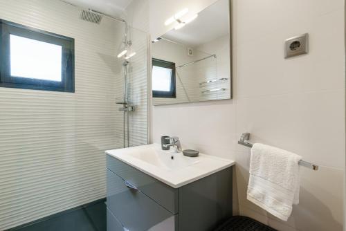 a white bathroom with a sink and a mirror at Sunny Side I Free heated pool in Tábua