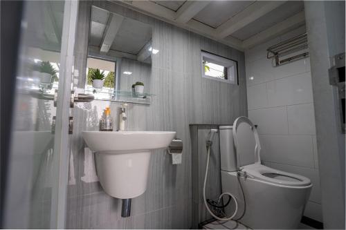 a bathroom with a sink and a toilet at Seven Terrace in Caringin