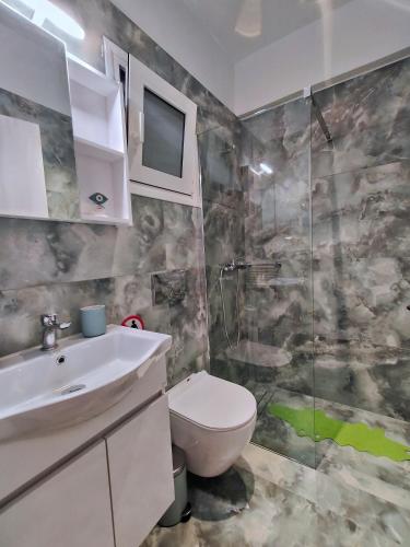 a bathroom with a toilet and a sink and a shower at Casa Napie Ioannina in Ioannina