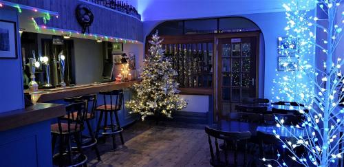 a christmas tree in a bar with christmas lights at The Mon Fort in Bridlington