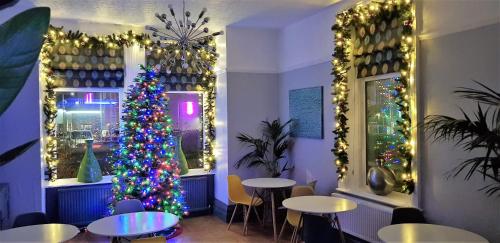 a christmas tree in a restaurant with christmas decorations at The Mon Fort in Bridlington