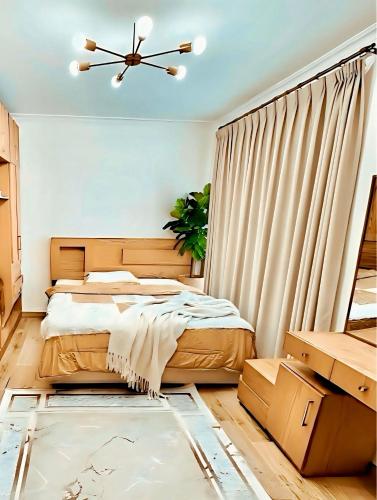 a bedroom with a bed and a ceiling fan at 2Bedroom Apartment and Living Room at Shiekh Zayed in Sheikh Zayed