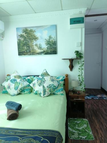 a bedroom with a bed with blue and white pillows at Villa Camille A8A in Grand-Baie
