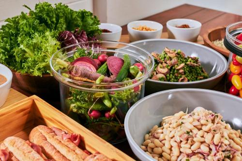 a table topped with bowls of different types of vegetables at edit x seven SETOUCHI SHODOSHIMA in Shodoshima