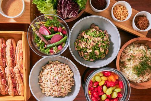 a table topped with bowls of different types of food at edit x seven SETOUCHI SHODOSHIMA in Shodoshima