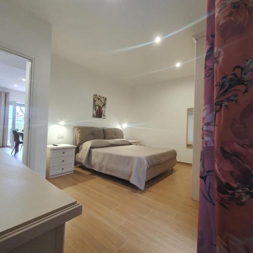 a bedroom with a bed and a dresser in it at Villa MelVin in Stazione di Paestum
