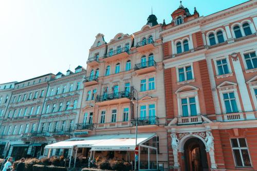 a large building in front of a building at Romania in Karlovy Vary