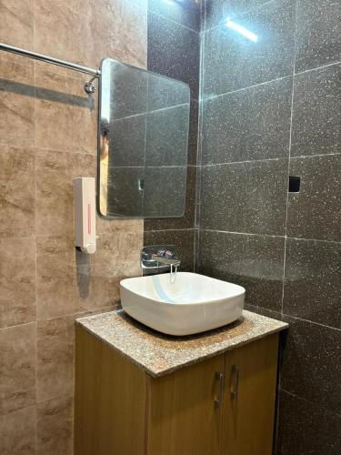 a bathroom with a sink and a mirror at Hotel Abline Rishikesh in Rishīkesh