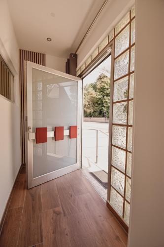 an open door to a patio with red chairs outside at Bicycle Lodge in Rehlingen-Siersburg