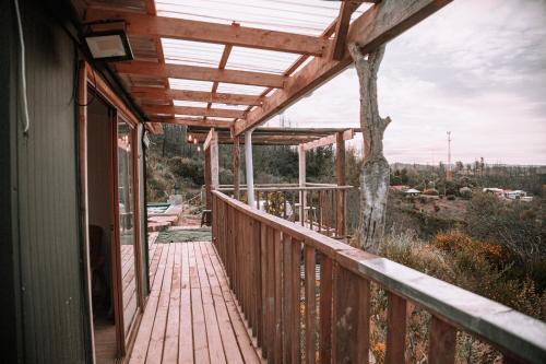 a wooden porch with a wooden walkway on a house at Dollinco Lodge in El Cerrillo