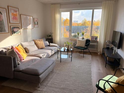 a living room with a couch and a table at Cozy, totally renovated apartment, sleeps 6 in Herning