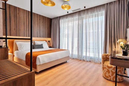 a bedroom with a bed and a large window at Acropolis Grid Athens in Athens