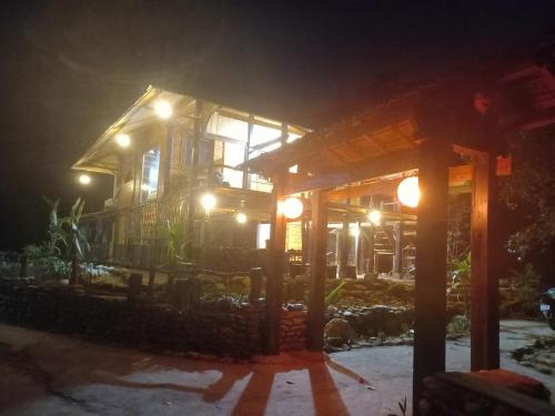 a house at night with lights on it at Tay Na Bon Homestay in Làng Lap