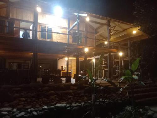 a house lit up at night with lights at Tay Na Bon Homestay in Làng Lap