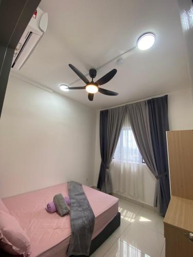 a bedroom with a ceiling fan and a pink bed at Traders park Balakong 3 room Wi-Fi balcony unblock view in Cheras