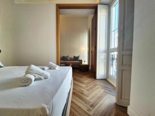 a bedroom with a bed with towels on it at Global Adriano luxury 1 in Seville