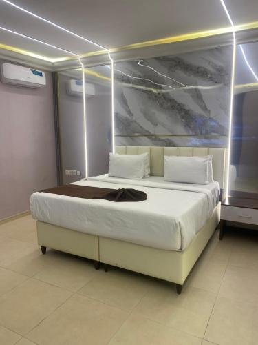 a bedroom with a large white bed in a room at Chateux de atlantique Hotel in Lagos