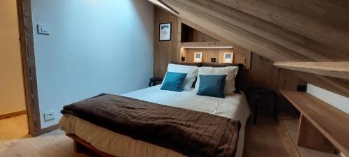 阿邦当斯Appartement Neuf 4 Pièces的卧室里有一张大床，配有蓝色枕头