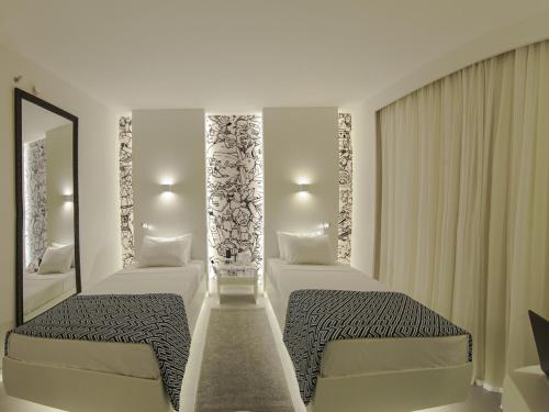 Ένα ή περισσότερα κρεβάτια σε δωμάτιο στο Golden Tower Maracanaú by Fênix Hotéis