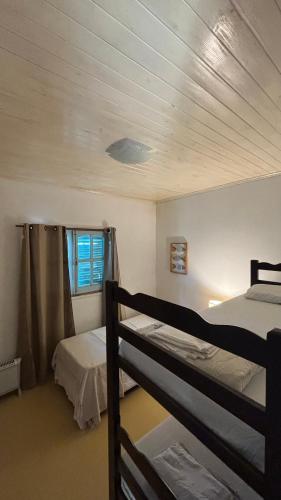 a bedroom with two bunk beds and a window at Casa en el Quebrachito in Formosa