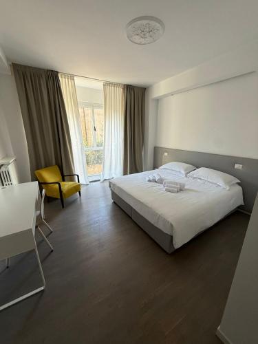 a bedroom with a bed and a table and a chair at Bovara 49 in Lecco