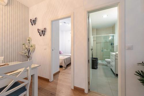 a bathroom with a glass door leading to a bedroom at Iconic Center in Seville