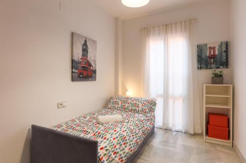 a bedroom with a bed in a room with a window at Fabled Parking in Seville