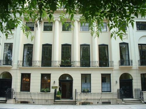 a large white building with windows and a door at The Goodenough Hotel London in London