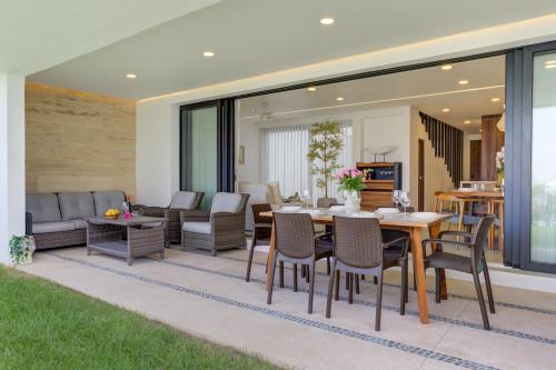 a patio with a table and chairs at Vista Natura, Luxury Home Near the Beach in Nuevo Vallarta 