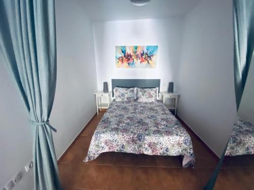 a bedroom with a bed and a painting on the wall at Vv Estrella in Puerto de Mogán