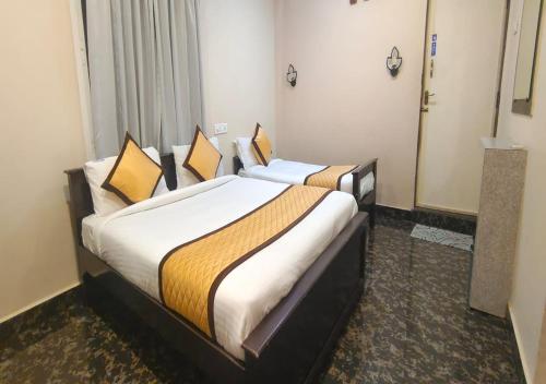 a hotel room with two beds in a room at bangalore residency in Srikalahasti