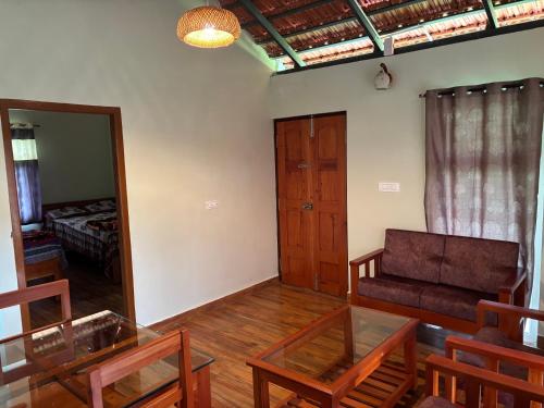 a living room with a couch and a mirror at Estate stay near Dubare elephant camp, friendly for remote workers in Siddapur