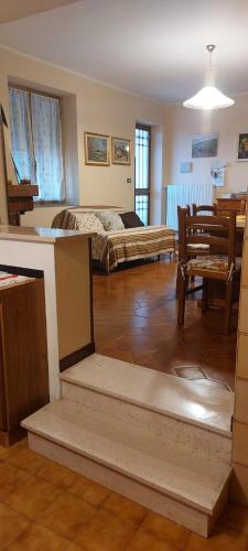 a living room with a bed and a dining room at Agriturismo A Cà du Paipèru in Pieve di Teco