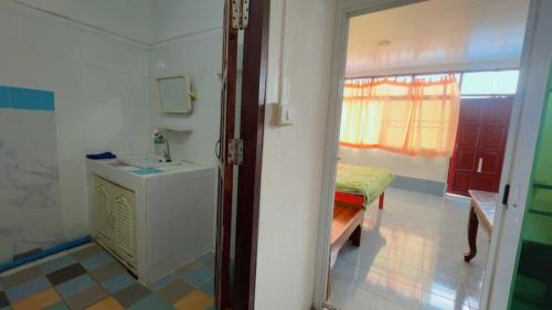 a bathroom with a sink and a bench in a room at OYO 75596 The Sirisuk House in Ban Nong Nae