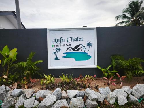 a sign for a yacht restaurant with palm trees at OYO 91244 Aufa Chalet in Kuala Terengganu