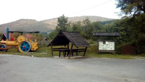 a playground with a tractor and a bench and a sign at Apartman Ana in Mokra Gora