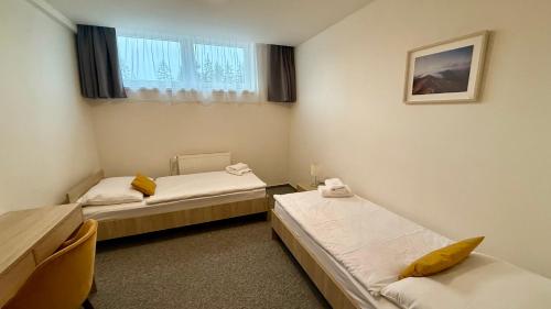 a room with two beds and a window at Chata Tale - Dom Horskej služby in Tale