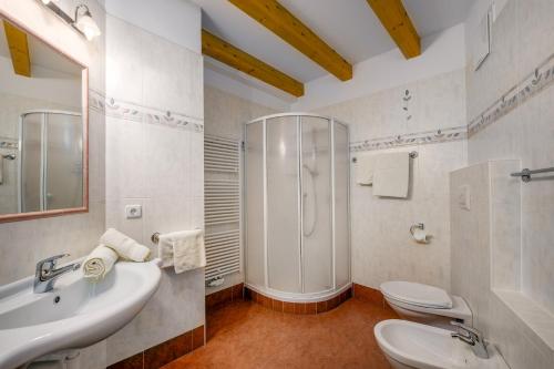 a bathroom with a shower and a sink and a toilet at Wieserhof Vals in Valles