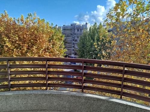 a wooden fence on a bridge with trees at apartman capljinka in Čapljina