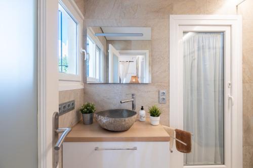 a bathroom with a sink and a mirror at Alegrías in Pla de na Tesa
