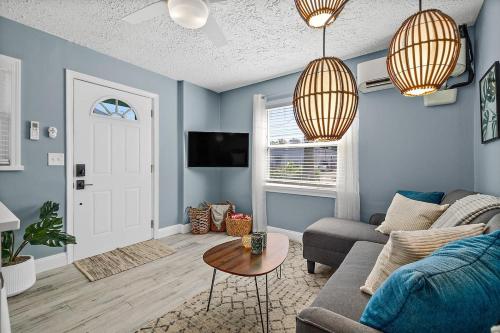 a living room with a couch and a table at Déjà Blue - Steps to the Ocean! in St. Augustine