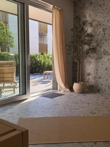 a room with a sliding glass door with a potted plant at KaiserLogen Wellness in Kaisersesch
