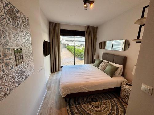 a bedroom with a bed and a large window at Student Experience Granada - Luxury Hostel in Granada